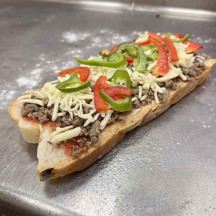 Coca recién horneada con carne, pimientos y queso